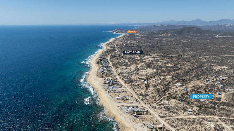 Aerial view showing the paved access road to Rancho Tortuga lots for sale and the nearby Vidanta East Cape development