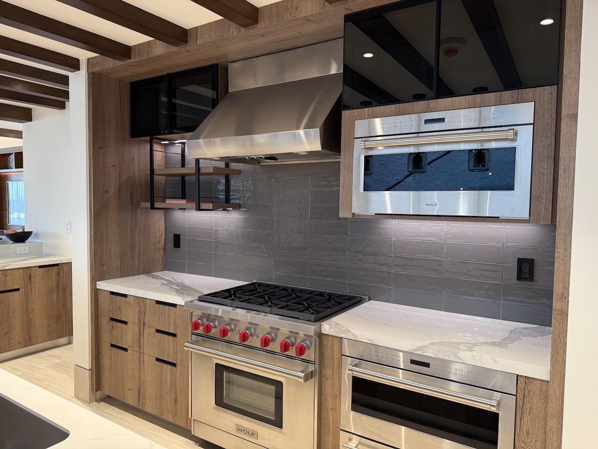 Modern gourmet kitchen in a St. Regis Cabo 3- or 4-bedroom condo featuring Wolf appliances, marble countertops, and an open floor plan with ocean views.