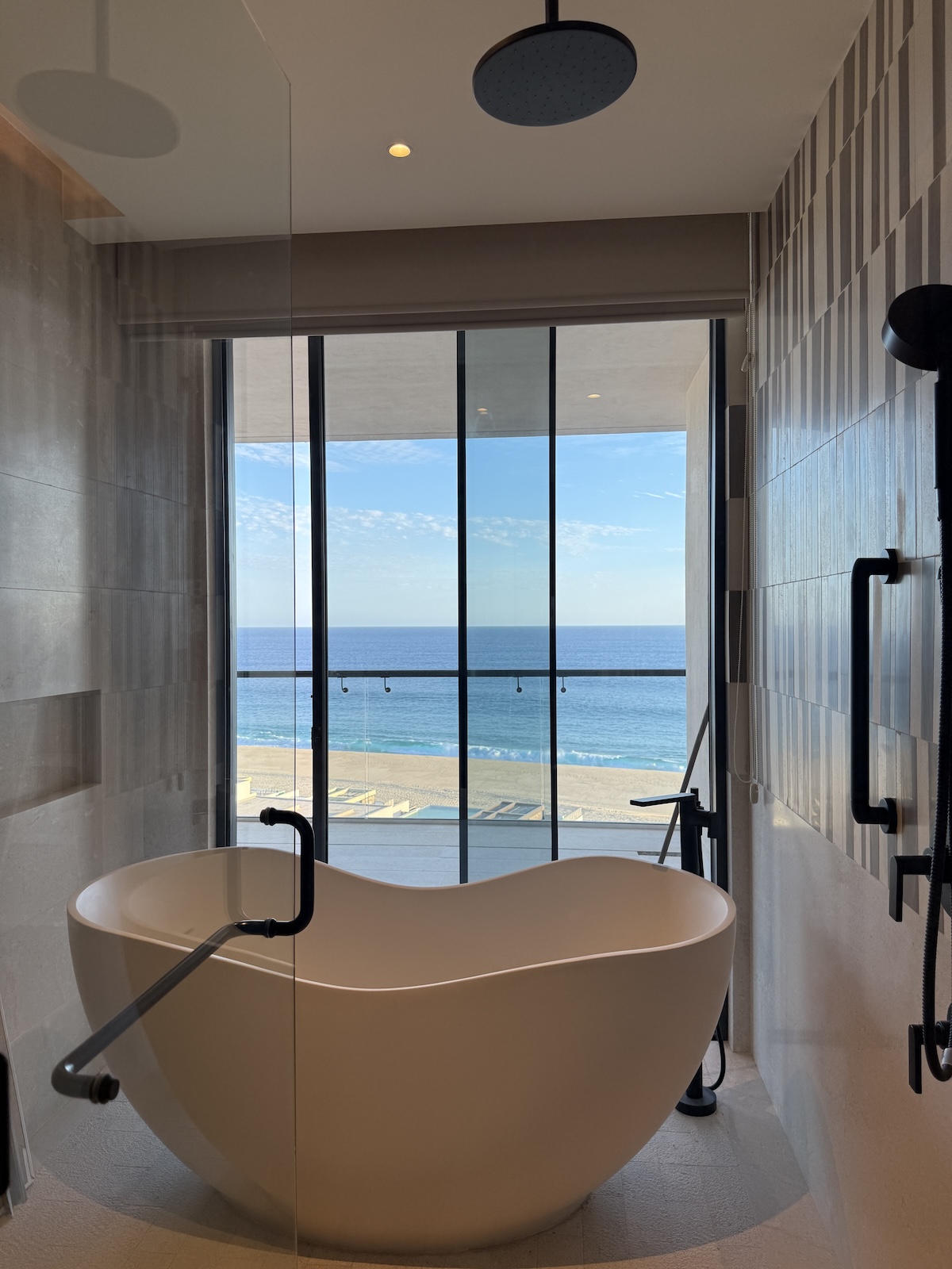Main bedroom ensuite bathtub in a St. Regis Cabo condo with floor-to-ceiling windows offering unobstructed oceanfront views